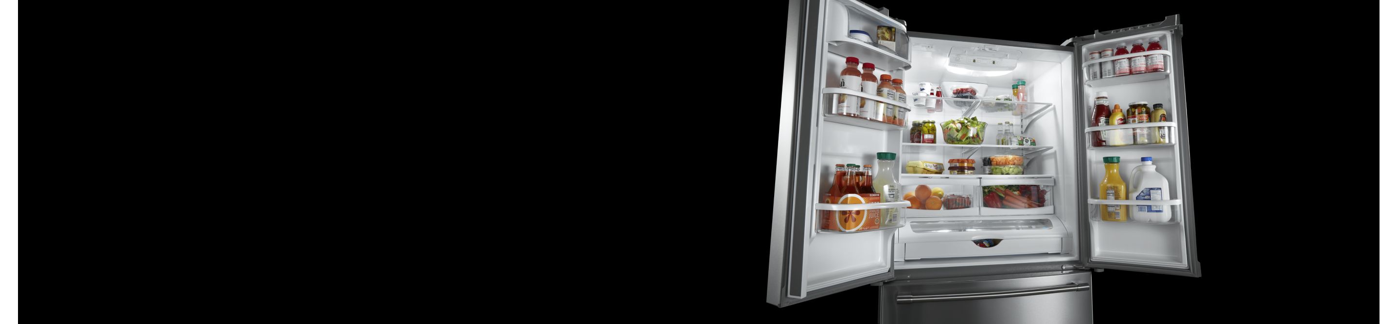 An open French door refrigerator with various food items inside