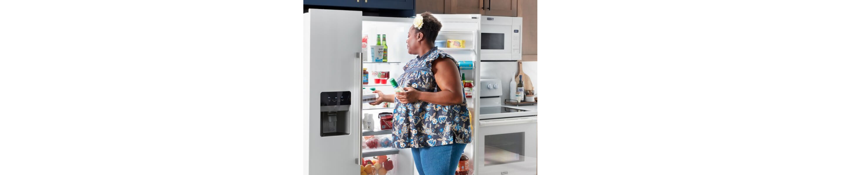 Person placing food inside a refrigerator