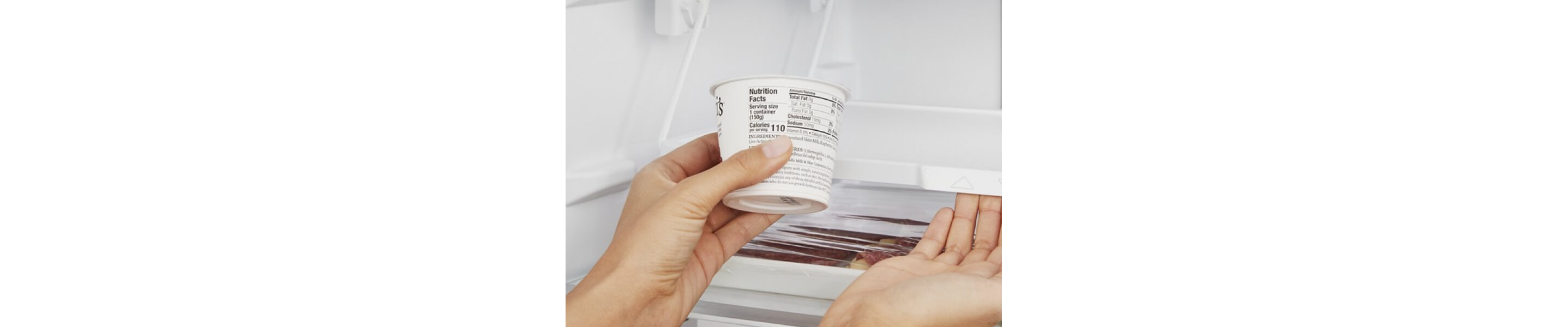 Person holding a cup of yogurt