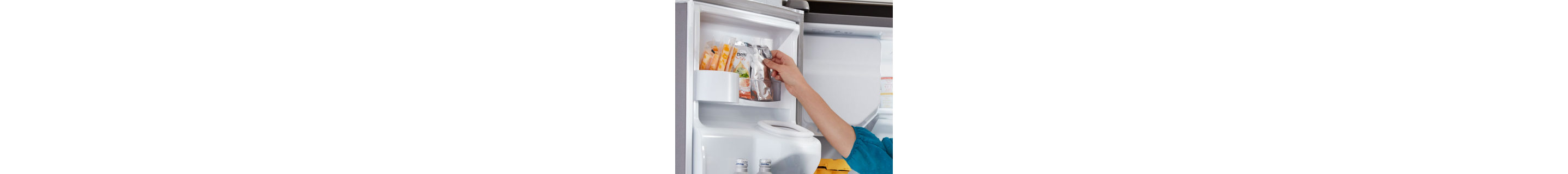 A person storing items in a fridge door shelf