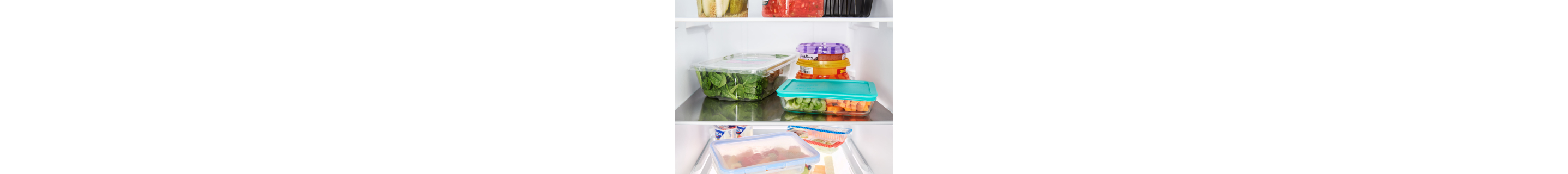 Containers of fresh ingredients stored on fridge shelves