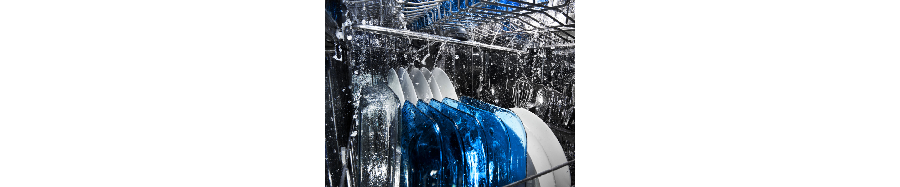 Plates and silverware being cleaned inside a dishwasher.
