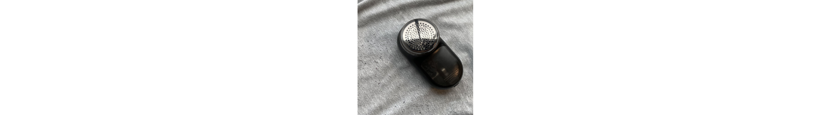 A fabric shaver on a pair sweatpants with fabric pilling