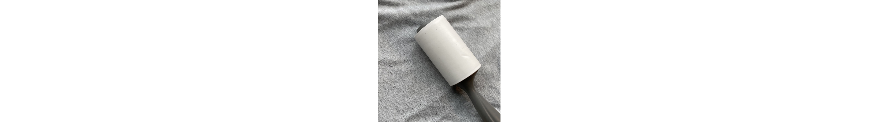 A lint roller on a pair of sweatpants with pilling