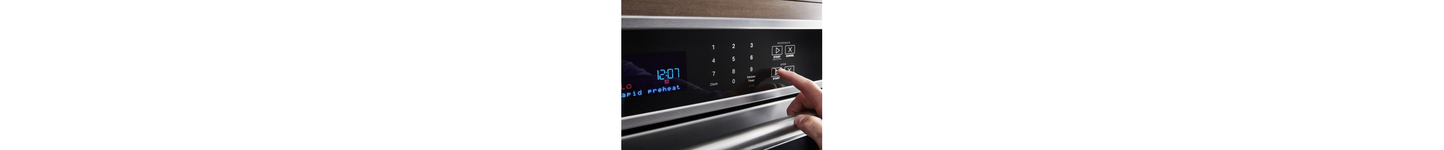 Hand pressing preheat on the oven console