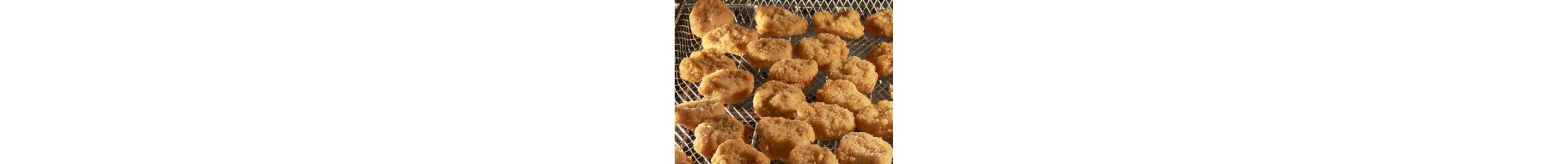 Fried chicken pieces in an air fry basket