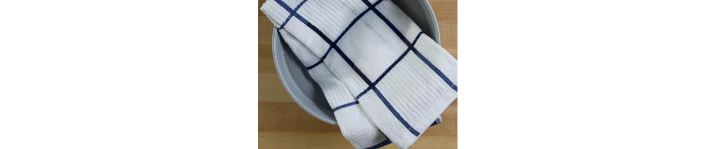 White washcloth soaking in a bowl of water and detergent