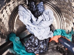 Person’s clothes agitating inside a washer drum