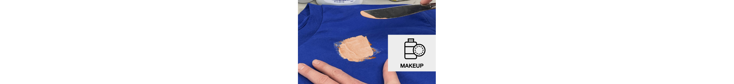 Person scraping makeup off a blue t-shirt
