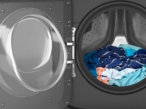 Opened washing machine with clothes inside