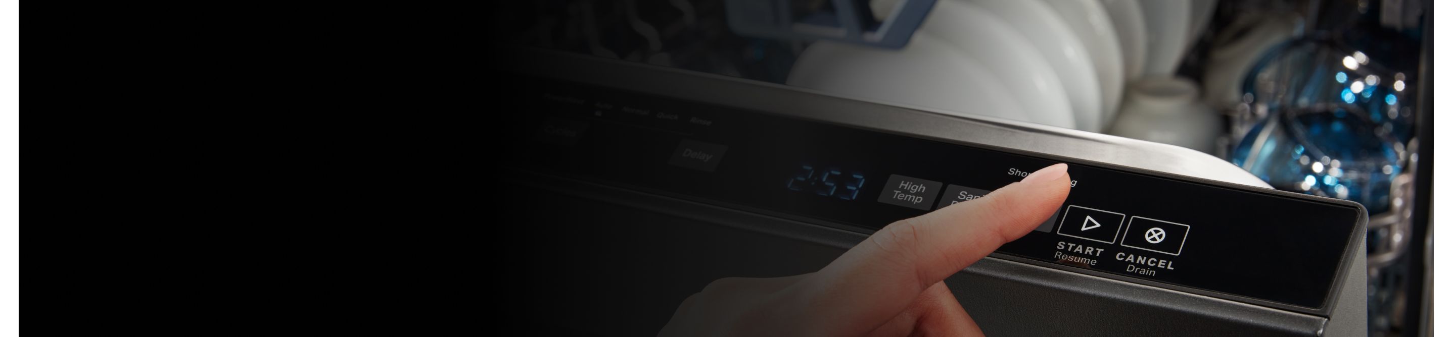 Finger hovering over “Start” button on dishwasher control panel