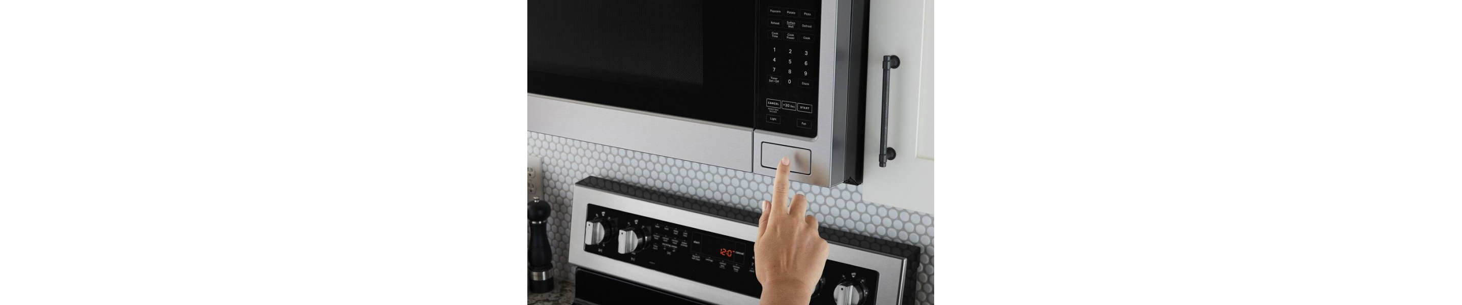 A closeup of a person programming a Maytag® microwave