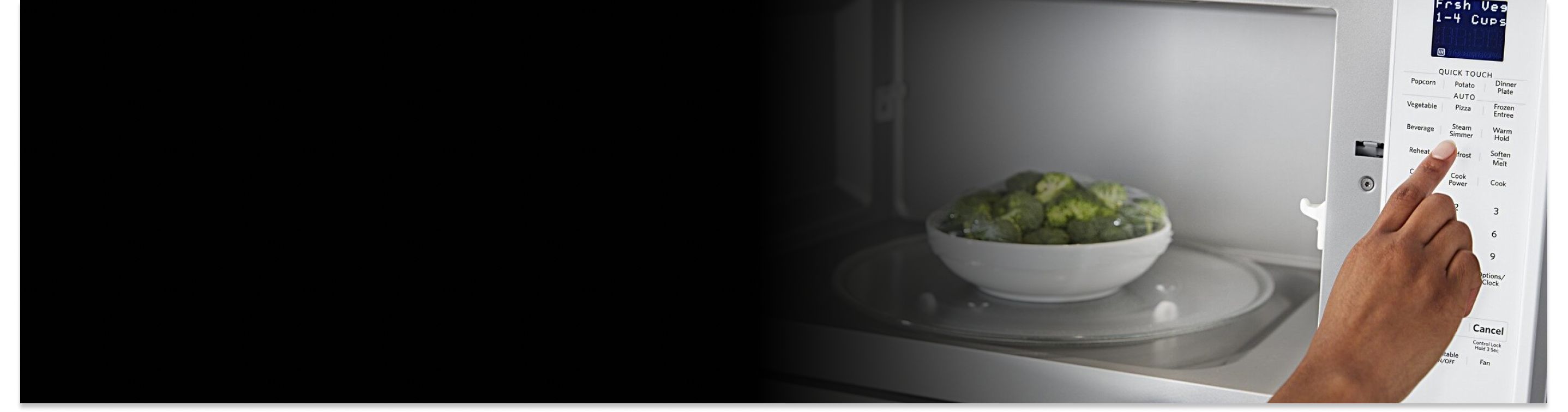 A person programming a Maytag® microwave with a bowl of broccoli