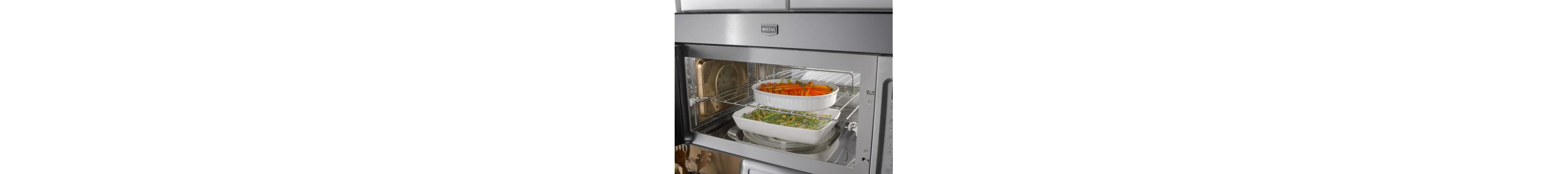 Inside of an open microwave with two dishes
