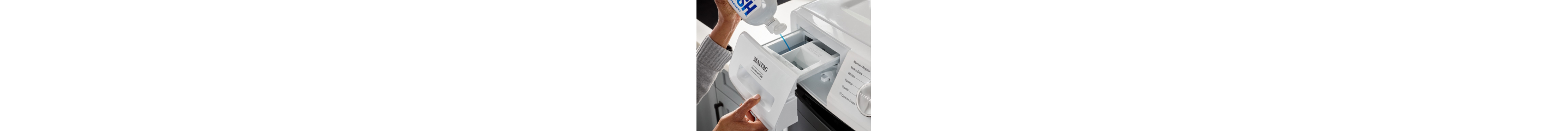 Person adding detergent to a washing machine