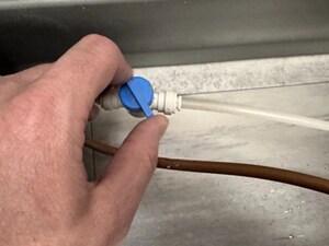  Person adjusting the control valve on a water line