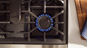 Bird's-eye view of a gas stovetop with a blue flame