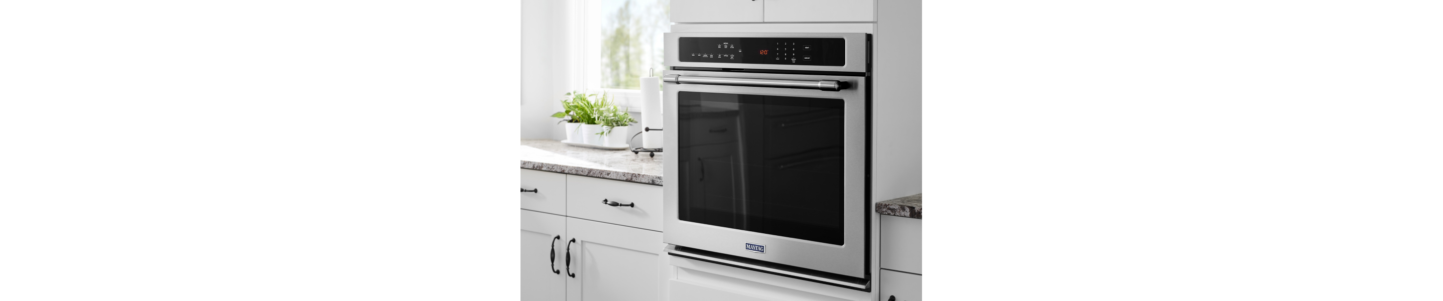 Stainless steel single wall oven from Maytag brand in white cabinetry