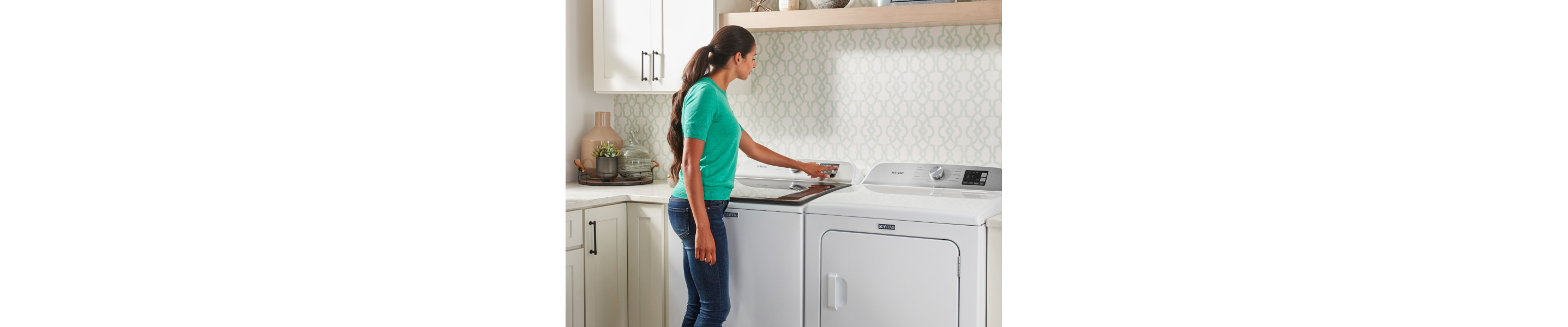 Person selecting a cycle on Maytag® washing machine