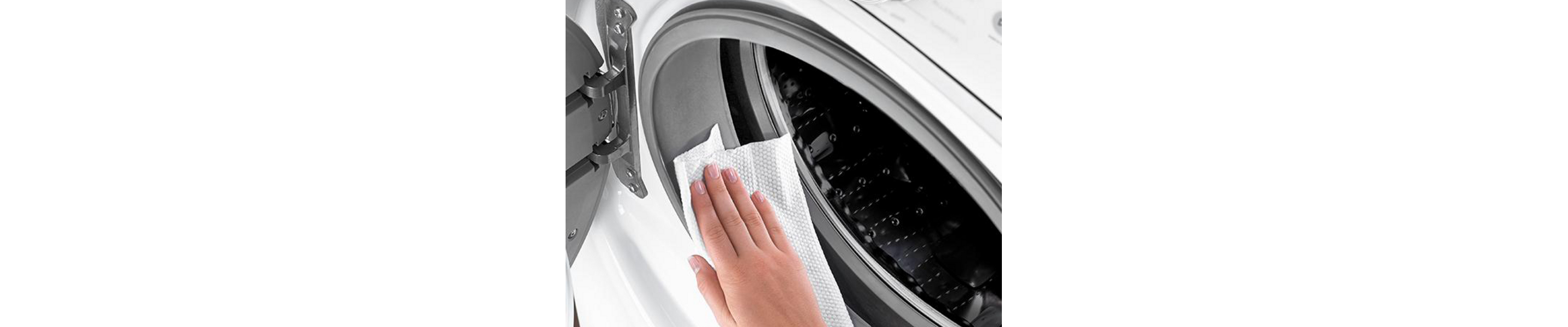 Person wiping door gasket on washing machine