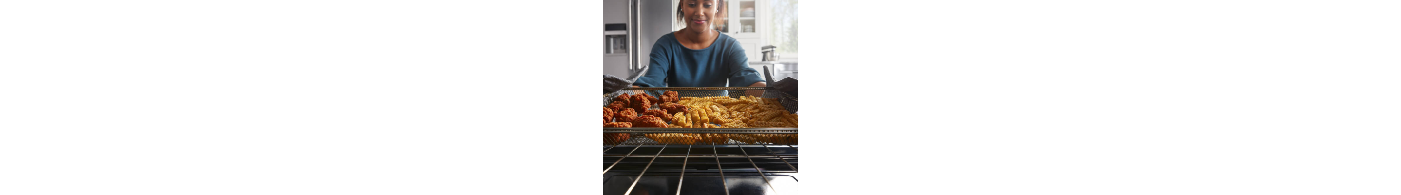 Person putting food in the oven