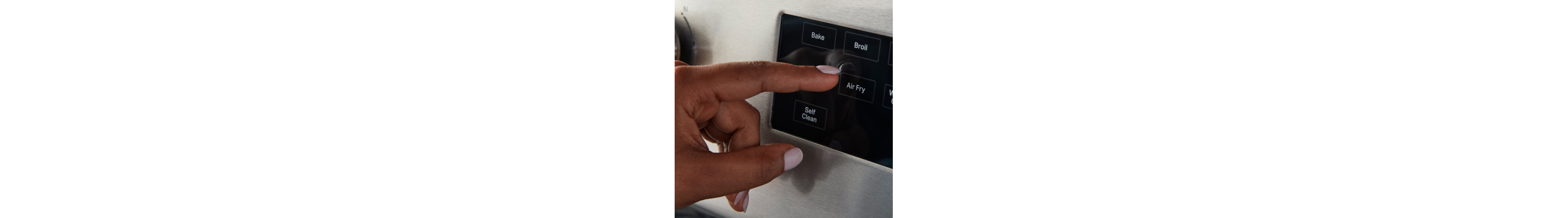 Person pressing air fry button on the oven