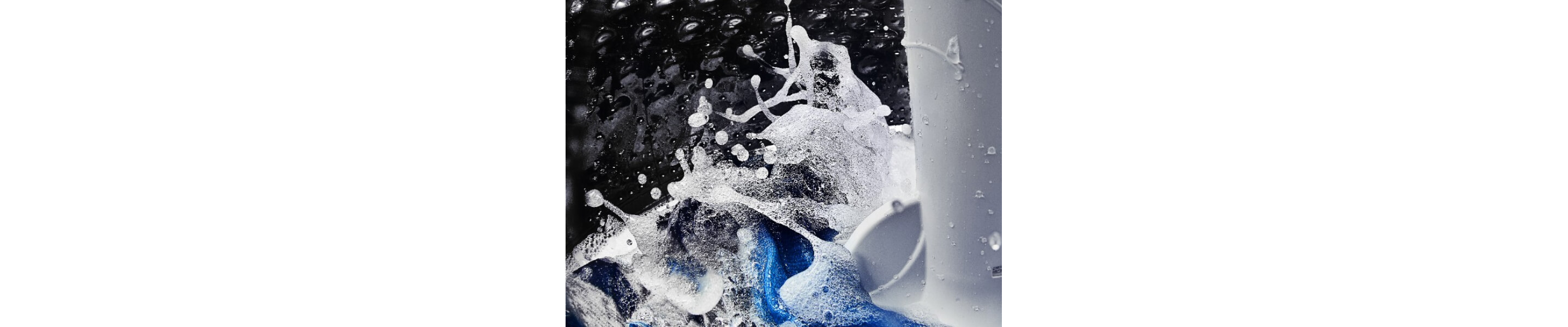 A close-up of the interior of a Maytag® washer tub with water