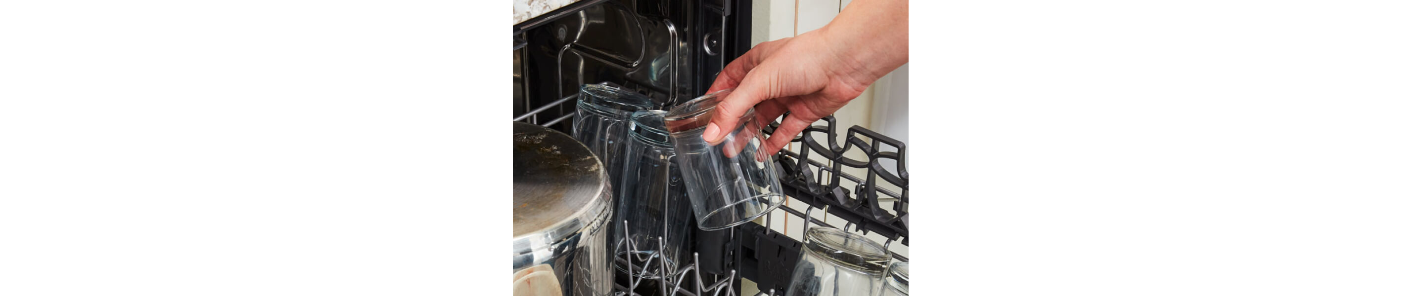 Loading a glass into the dishwasher