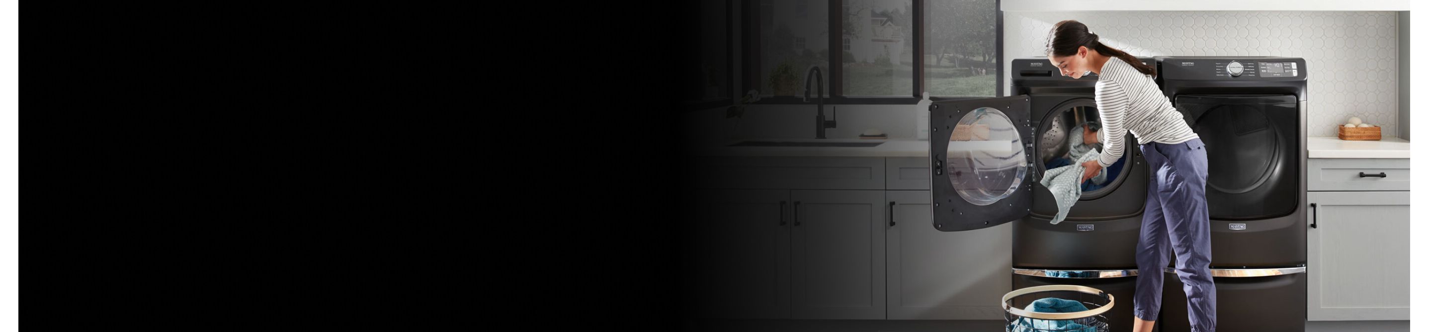 Person doing laundry with a Maytag® washing machine
