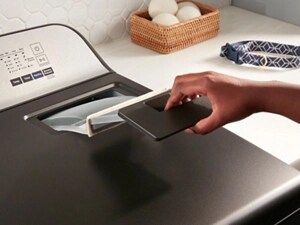 Person removing lint trap from dryer