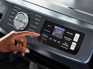 Someone operating the control panel of their Maytag® Pet Pro Washer