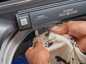 Someone hand washing an item using the Built-In Water Faucet on their Maytag® washer