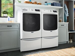A laundry room in a home with a Maytag brand washer and dryer side by side