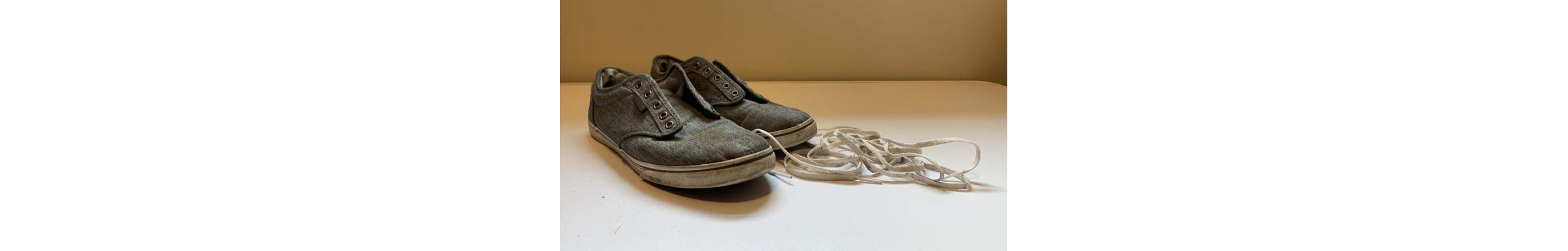 Dirty shoes with shoe laces removed
