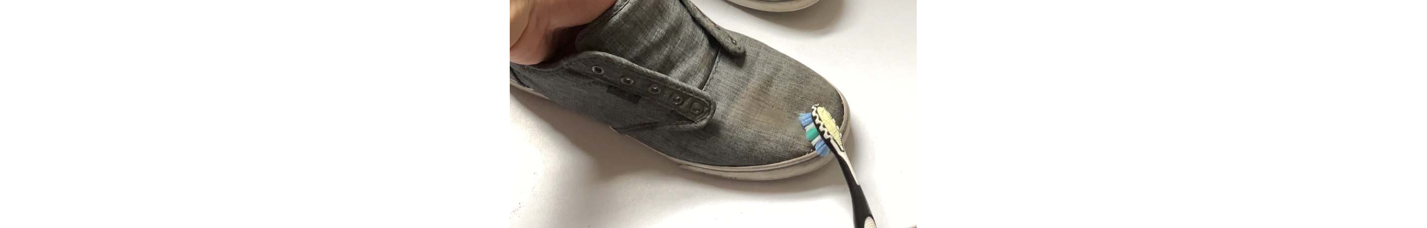 Shoes being cleaned with a toothbrush