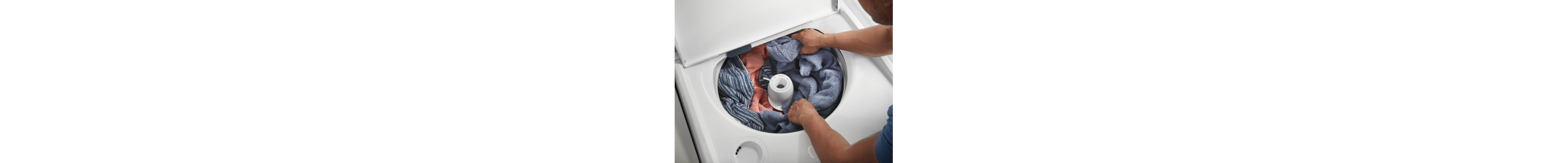 Person distributing clothes around washer agitator