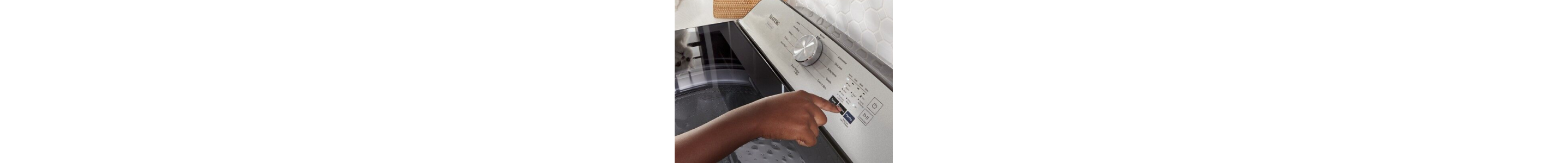 Person selecting cycle settings on washing machine
