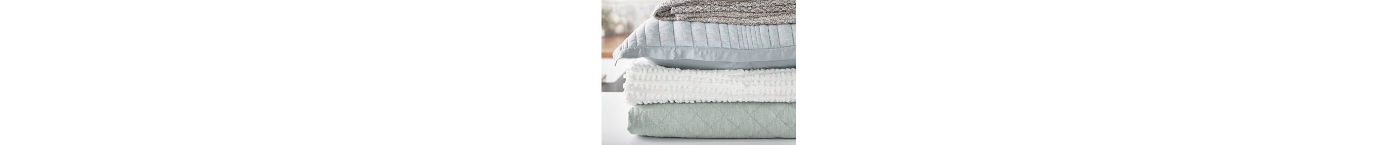 Stack of folded blankets and pillows