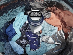 A Maytag® Pet Pro Filter in a washer filled with water