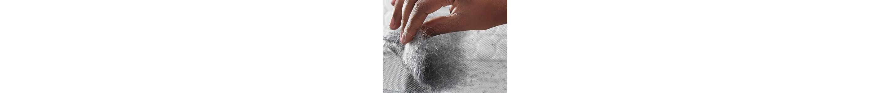 Hand removing a clump of pet hair