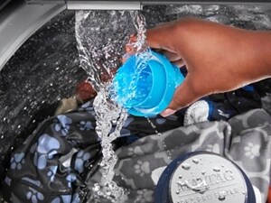 Person rinsing detergent cap