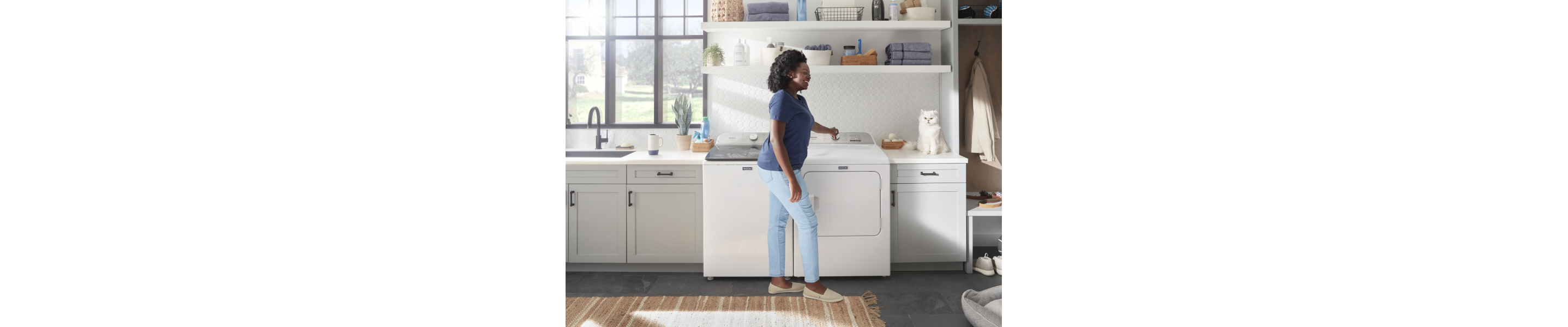Person loading a Maytag® Washer.
