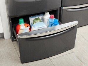 A laundry pedestal stocked with detergents, cleaners and fabric softener