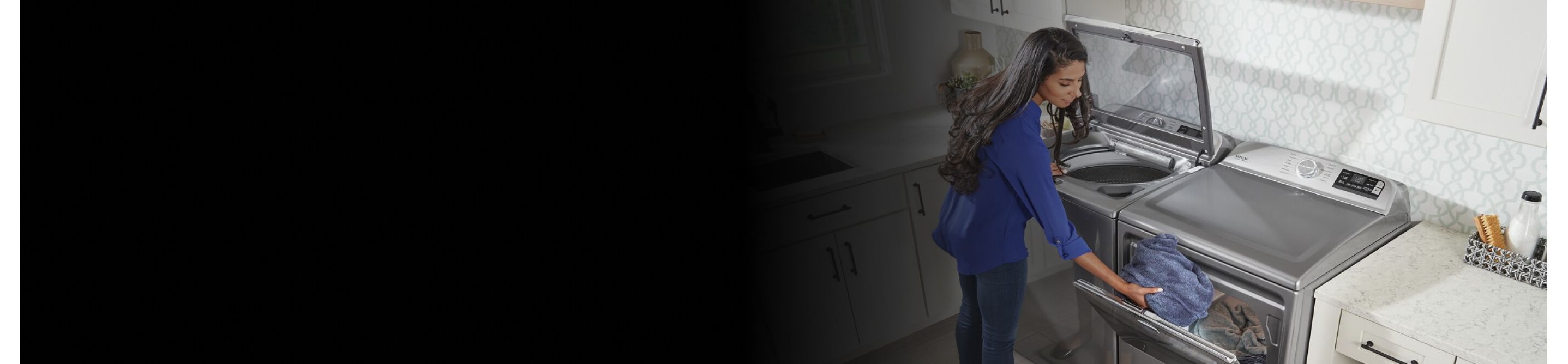 Person transferring clothes from gray, top-load Maytag® washer to a matching dryer