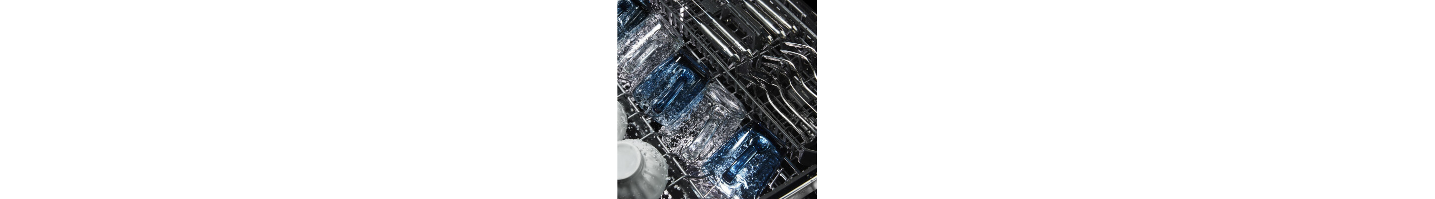 Close-up of cups washing in the upper rack of a dishwasher
