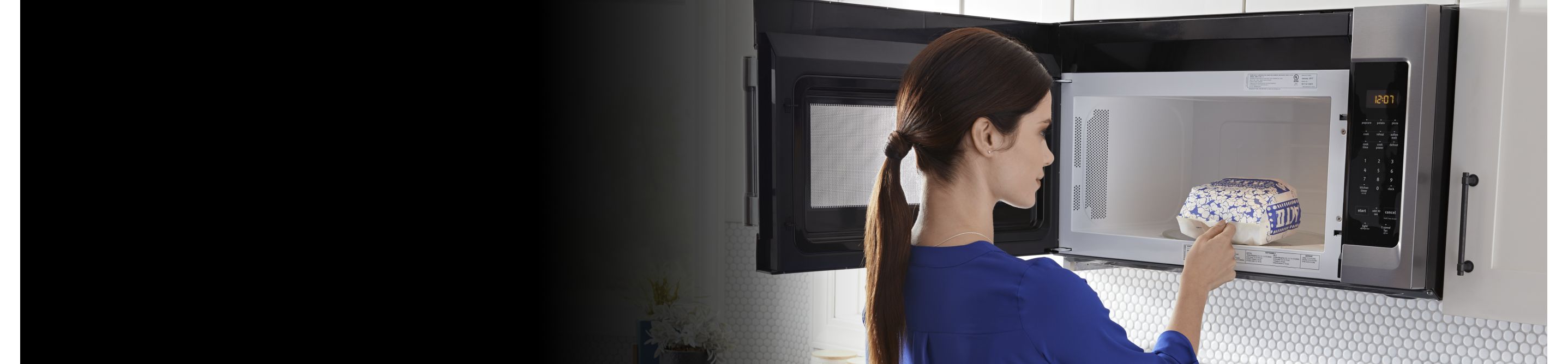 Person removing popcorn from the microwave