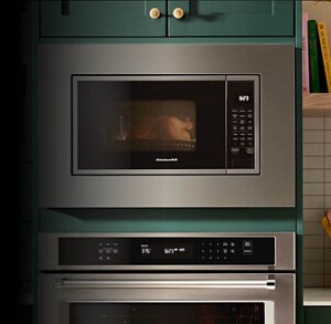 Microwave built into cabinetry with a trim kit