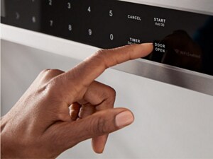 Person choosing settings on a microwave control panel
