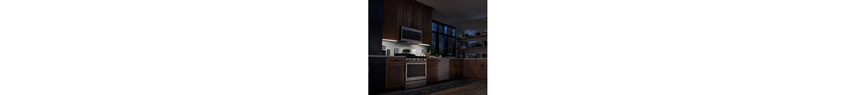 Maytag® over-the-range microwave casting light on stovetop below