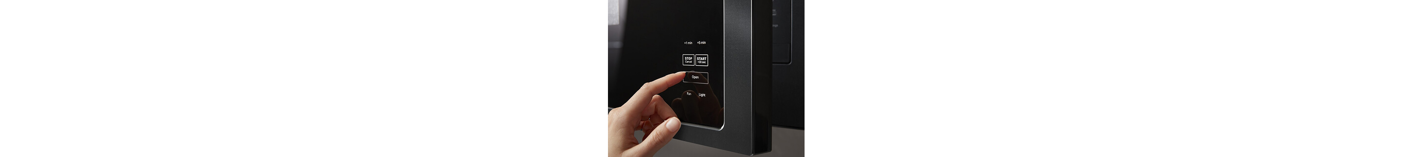 Person selecting button to open an over-the-range microwave